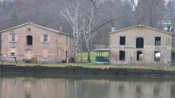 The old rotted docks have been removed from the creekside of Lynch’s Marina, as have the old, damaged, non-historic windows. (photo by Robert Ford)