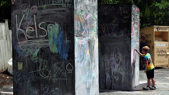 A young artist draws on the walls at Water Street Market's Chalk Festival in 2014. (photo by Lauren Thomas)