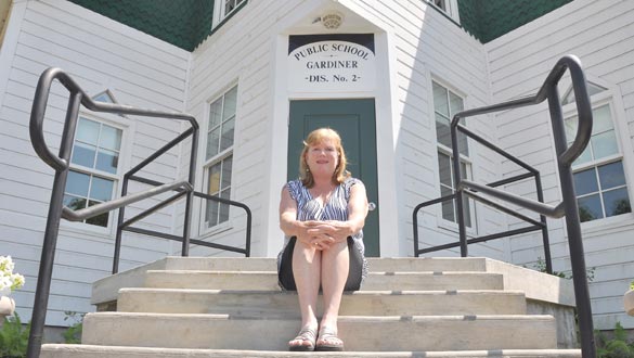 Gardiner Town Supervisor Marybeth Majestic sits on the steps to the new entryway to Gardiner Town Hall. The carpentry and door installation was performed by Ultimate Homes, Inc and the masonry was done by D&A Masonry. (photo by Lauren Thomas)