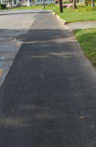 The dark patch of asphalt laid down during the recent natural-gas line replacement project will be white-lined by the DPW as a pedestrian walkway along Washington Avenue. (photo by Robert Ford)