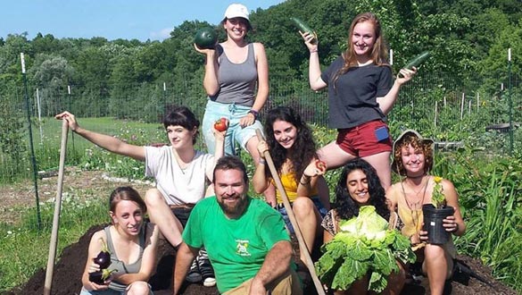 On the top of the college student compost pile are, top, Billie Golan and Daisy Goldstein; middle, Julia Brito Carlin, Alana Commando and Brenna Rathbone; and bottom row, Annie Filippone, Michael Essig and Laraib Ali. (photo by Billie Golan)