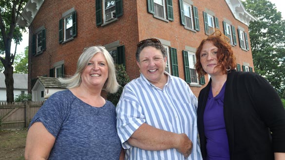 Julie Robbins, new president of the Arts Community; Joanne Still, former vice president and board member of the Arts Community; and Nicole Langlois, new vice president of the Arts Community, in front of One Epic Place. Not pictured is Peggy Paparone, former president of the Arts Community. (Lauren Thomas | New Paltz Times)
