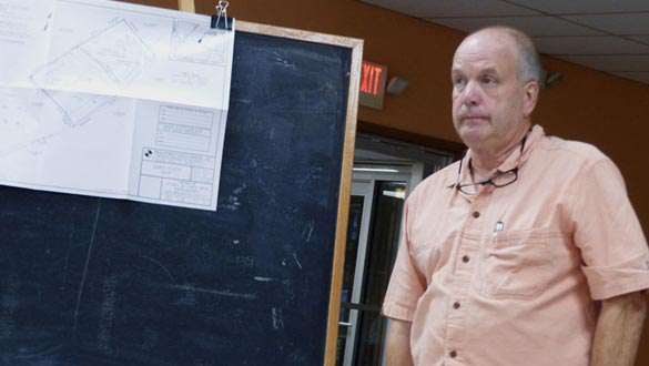 Surveyor Tom Conrad of Praetorius and Conrad describes Jaysen and Loren Beth Abrahamsen’s plans. (photo by David Gordon)