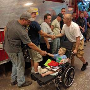 Kellan and his father thanking firefighters
