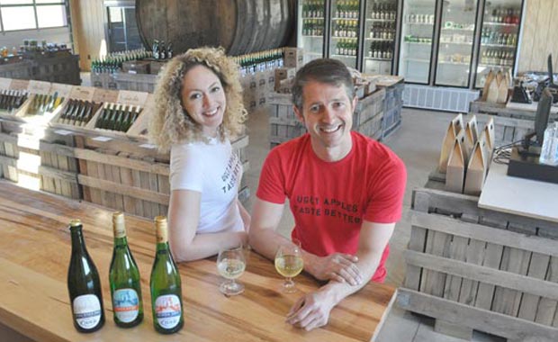 Lindsey Storm and Mikel Martiararena with a selection of beverages from Brooklyn Cider House in the tasting room and farm market at Twin Star Orchards in New Paltz. (Lauren Thomas | Almanac Weekly)