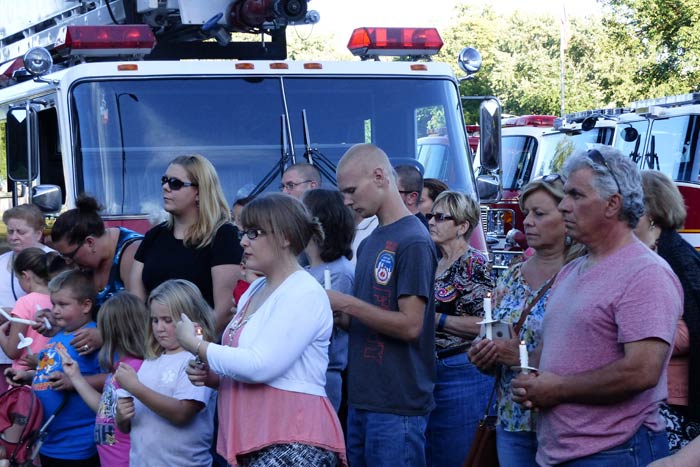 Members of the public attending the observance hold candles in memory of the victims of the September 11, 2001 attacks. (photos by David Gordon)