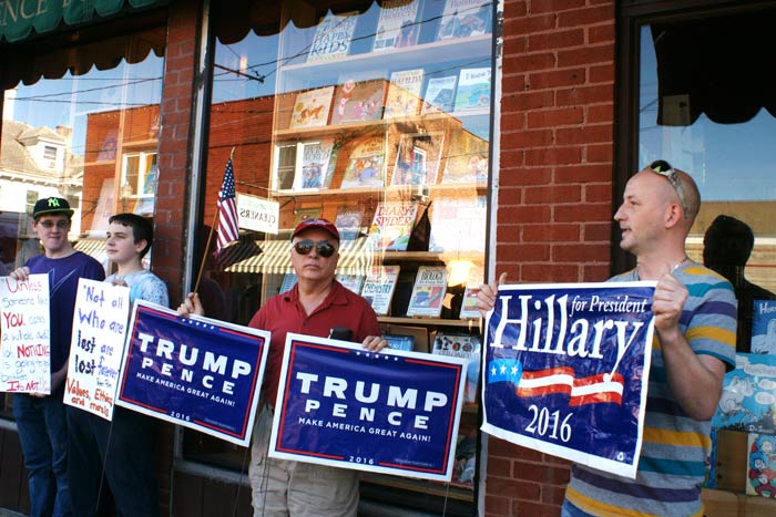 Opposing demonstrators Trump supporter Robert Morales and Clinton supporter Charles Potter outside the bookstore.