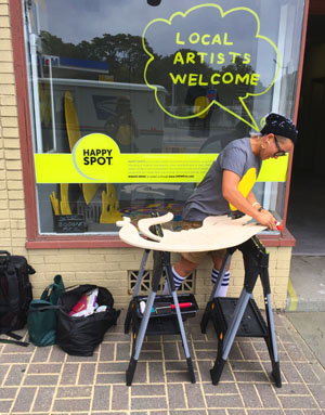 boogieREZ, a participating community artist, sawing out a portion of her three-dimensional graffiti Happy Spot. Her final Happy Spot stands more than nine feet tall, and it will be installed in surprise locations in Midtown Kingston this winter.